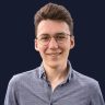 cropped-profo_segments_compr.jpg A picture of Tobias, with glasses, short brown hair, and a light blue button-up shirt.